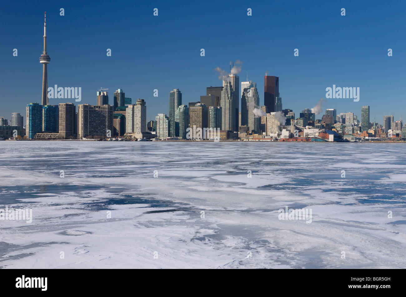 Frozen Lake Ontario with ice and snow and Toronto city skyline on a clear cold day with blue sky Stock Photo