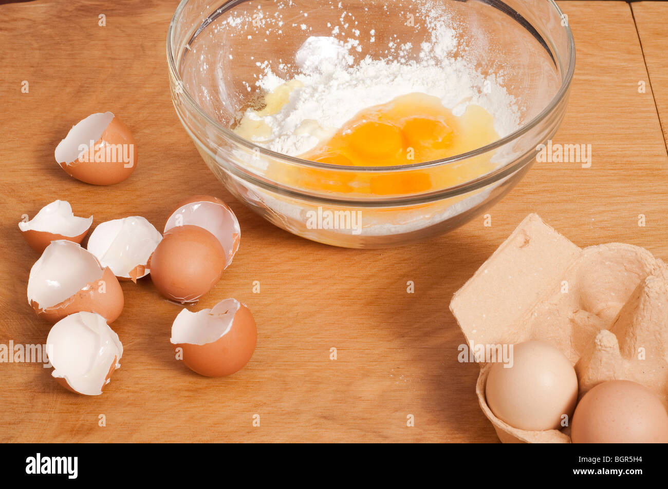 Mixing bowl of flour with eggs shells Stock Photo