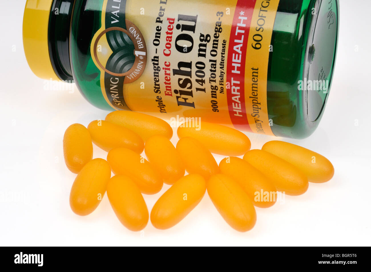 Softgel caplets and a bottle of Fish Oil dietary supplement. Stock Photo