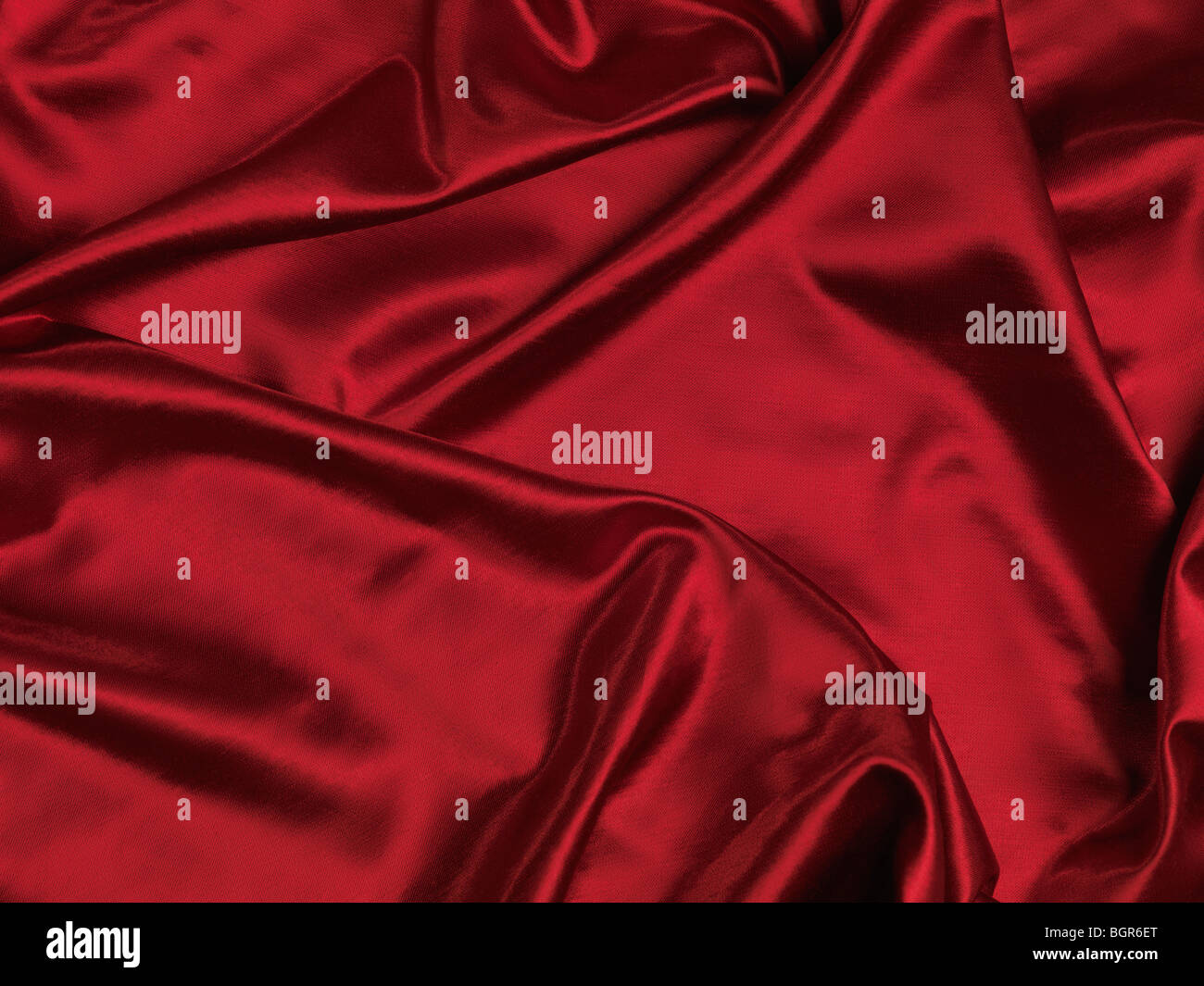 Red shiny silky fabric background Stock Photo