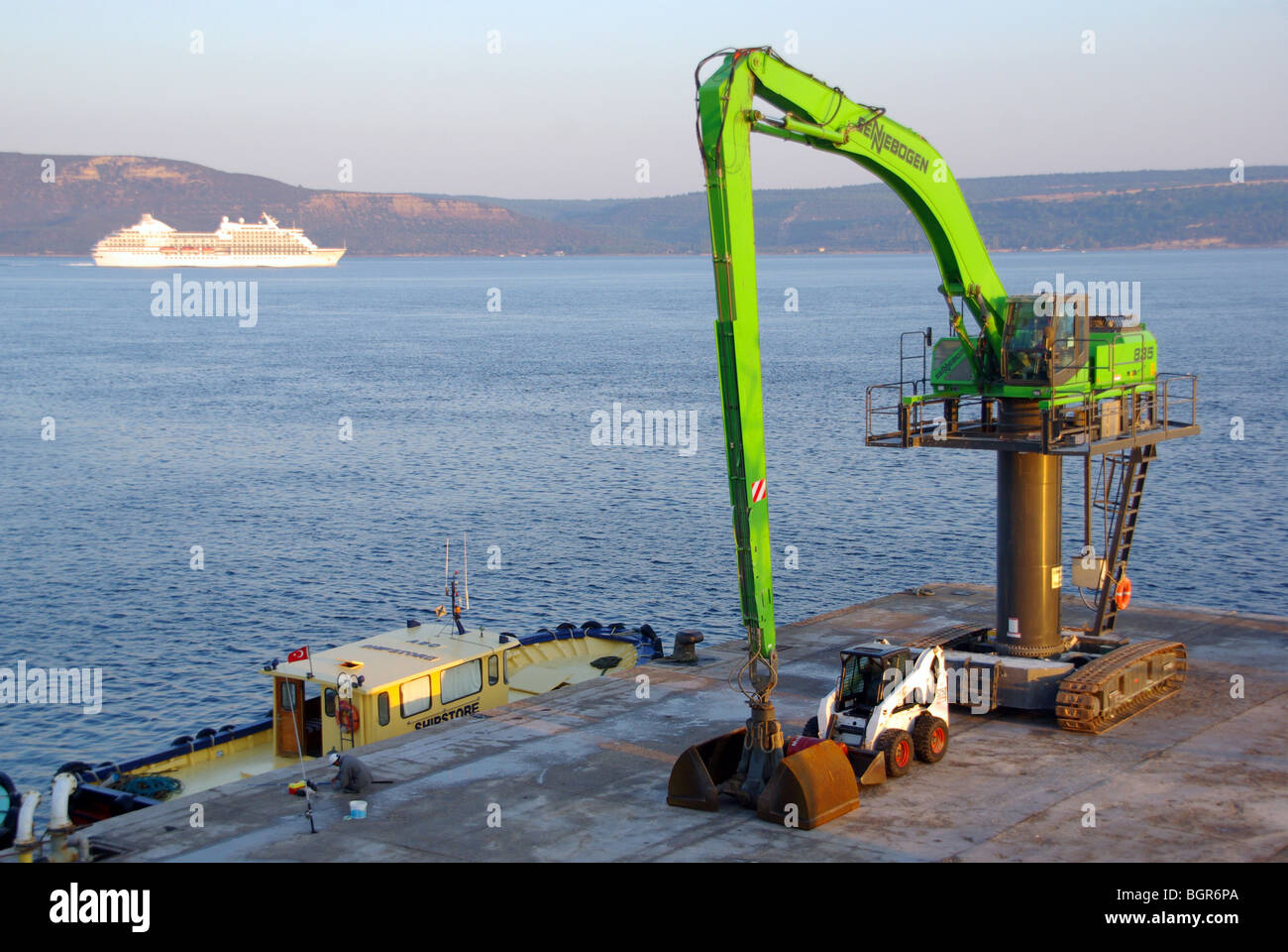 Canakkale dockyard mobile crane tracked vehicle with caterpillar tracks parked on quay beside small loader Turkey Asia Stock Photo