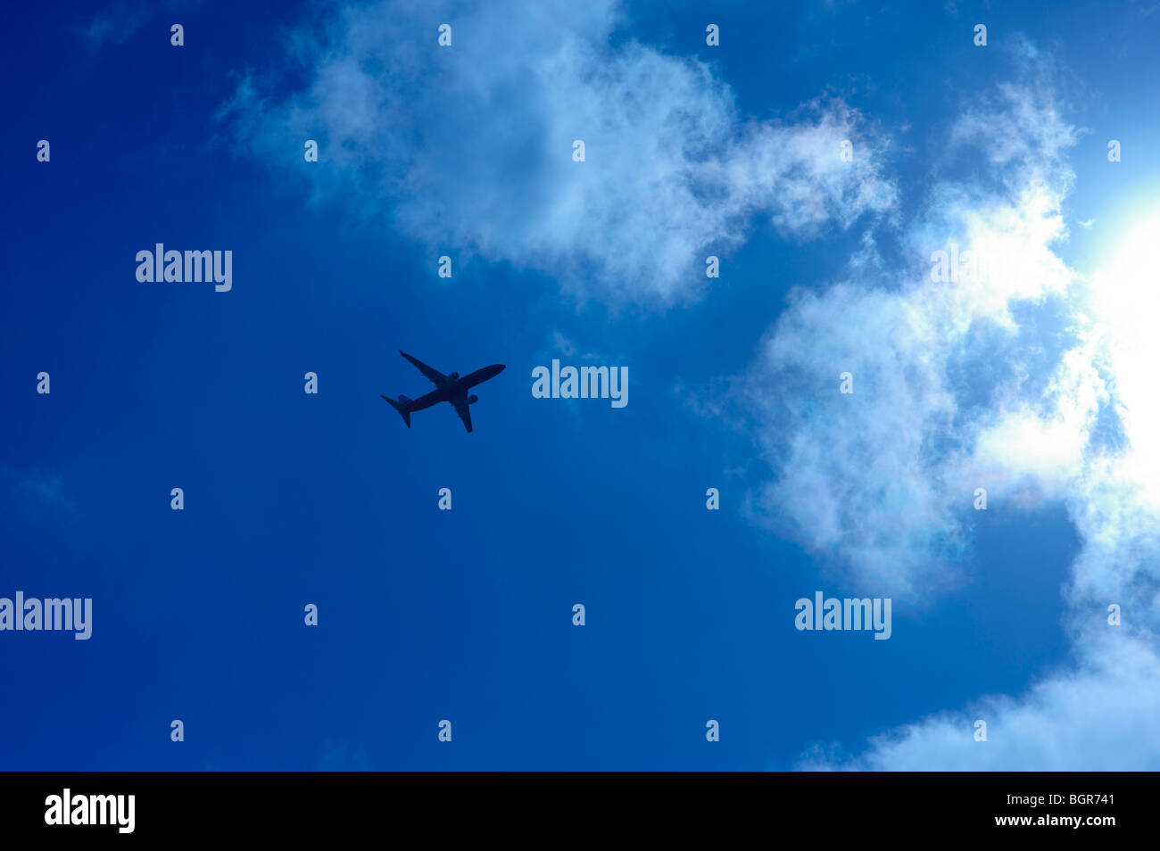 Airliner flying into the sun Stock Photo