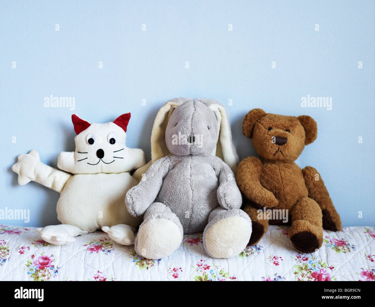 Three toy animals on a bed Stock Photo