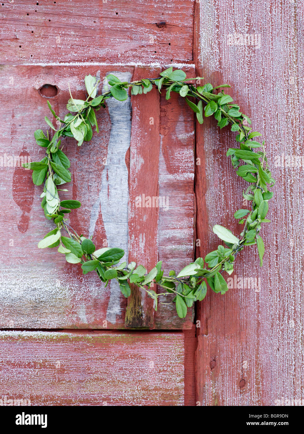 A garland hanging on a wooden door, Sweden. Stock Photo