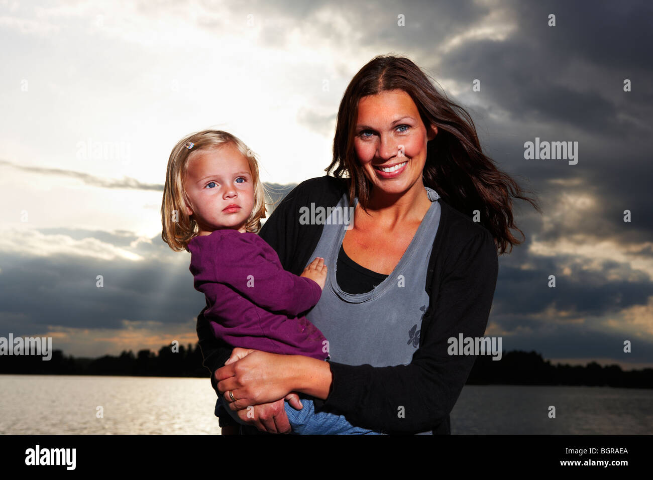Mother and daughter by the sea. Stock Photo
