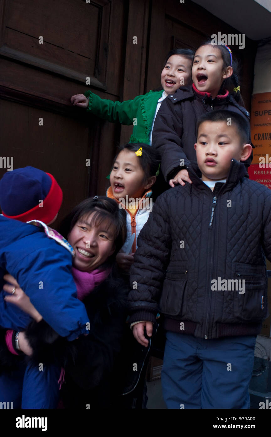 Paris, France, Medium Group People, Street Scene, Chinatown, Young Asian immigrants minority family, Children, Child Watching parade at 'Chinese New Year' Celebrations Stock Photo