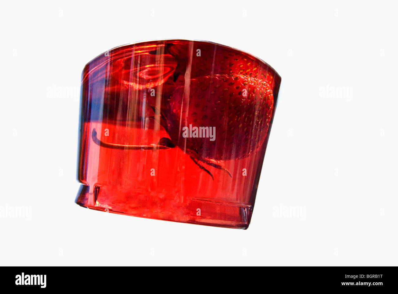 A strawberry in a glass of bowl, close-up Stock Photo - Alamy