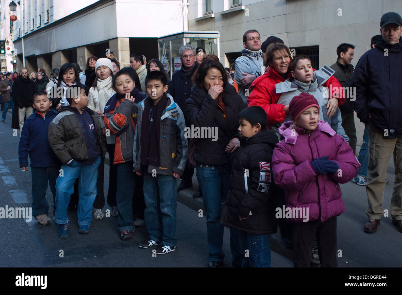 Paris, France, Large Crowd People, Street Scene, Chinatown, Young Asian immigrants minority family Watching pa-rade at 'Chinese New Year' Celebrations, immigrants Europe, chinese crowd faces Stock Photo