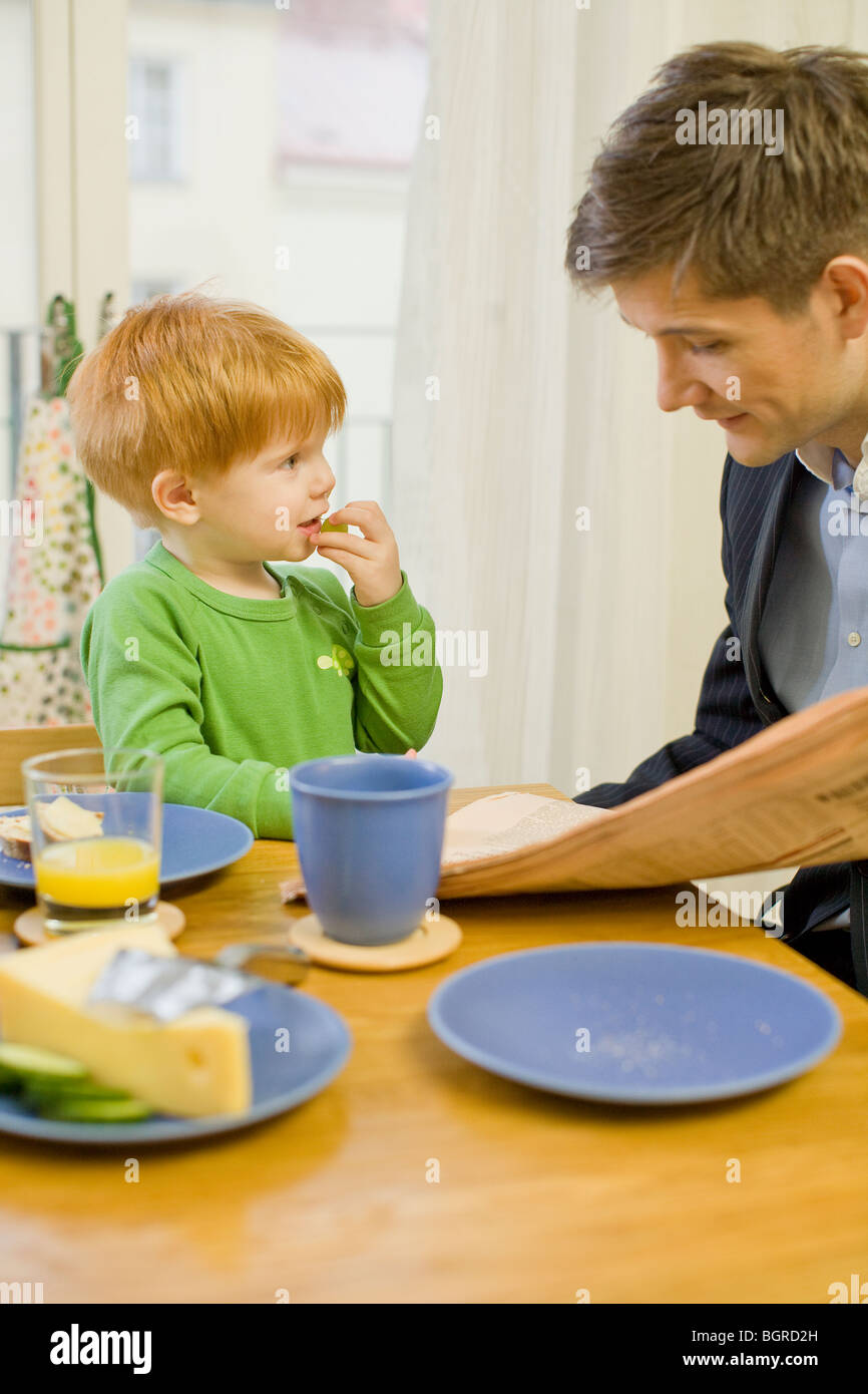 Father and son having breakfast, Sweden. Stock Photo