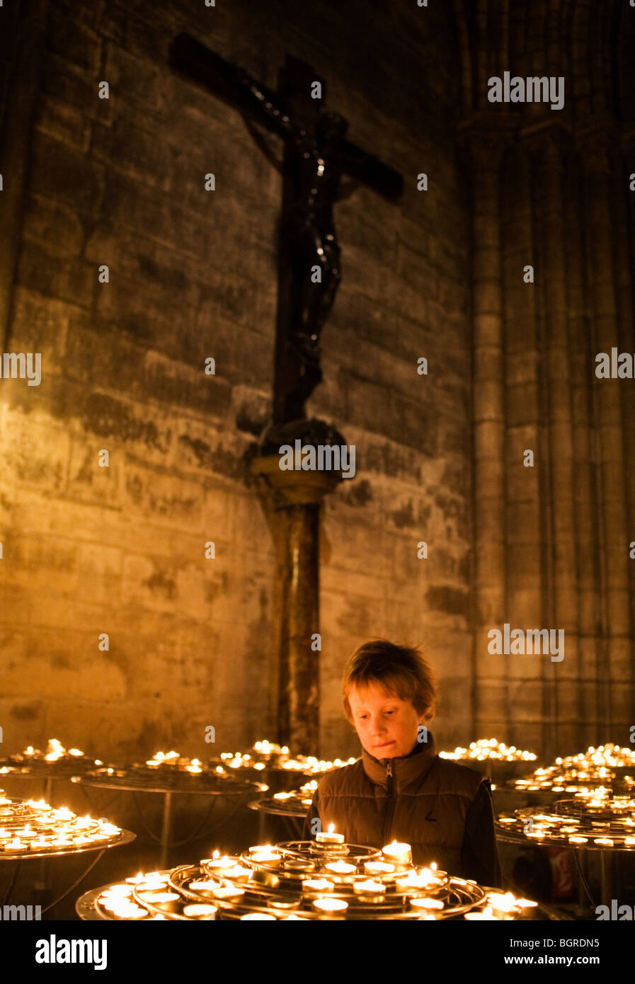 A boy inside of Notre Dame, Paris, France. Stock Photo