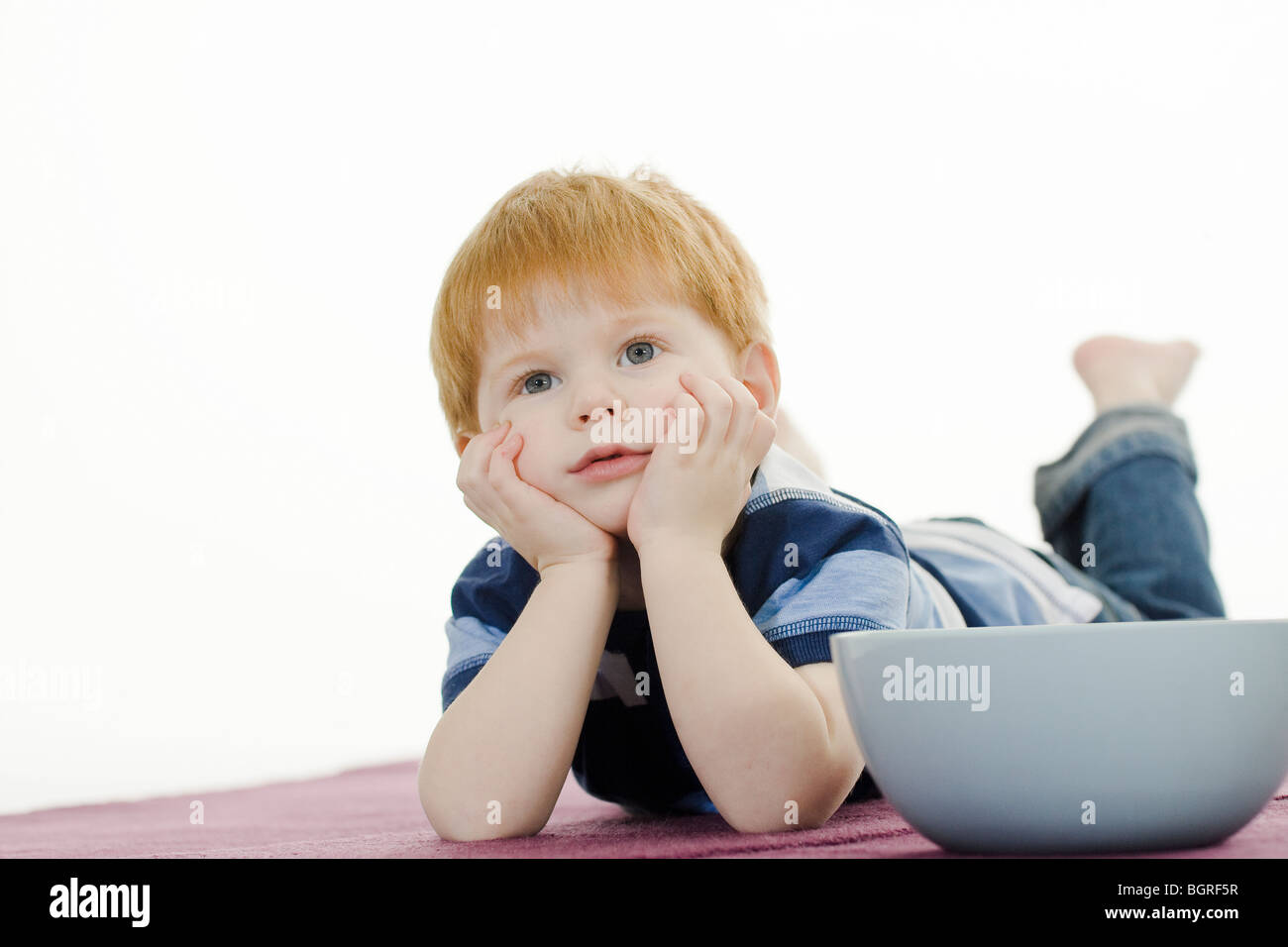 Boy with a bowl of popcorns. Stock Photo