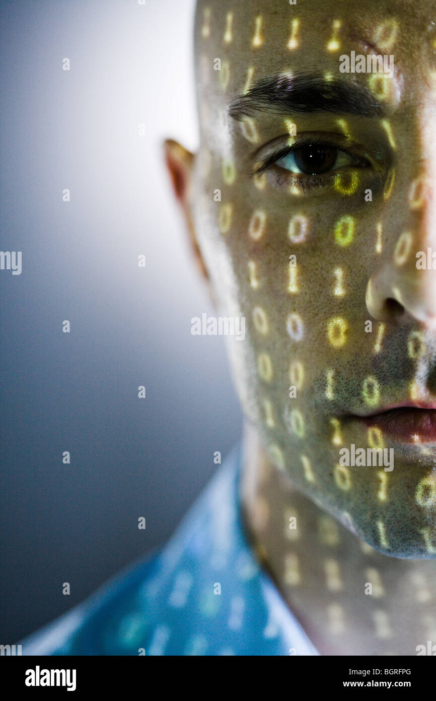 Close-up of a man with digital numbers reflected on his face. Stock Photo