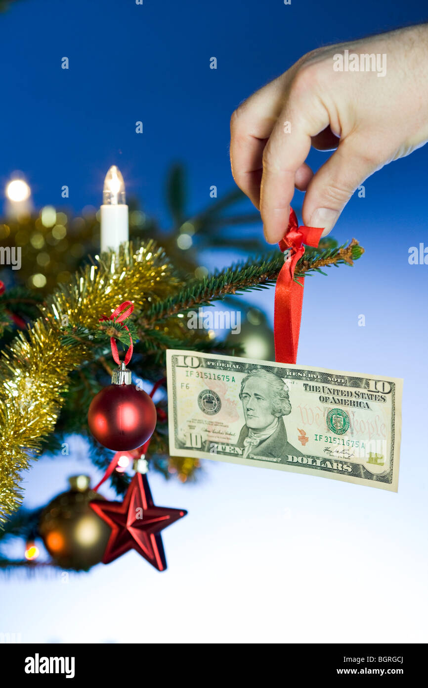 A dollar bill hanging in a Christmas tree Stock Photo Alamy