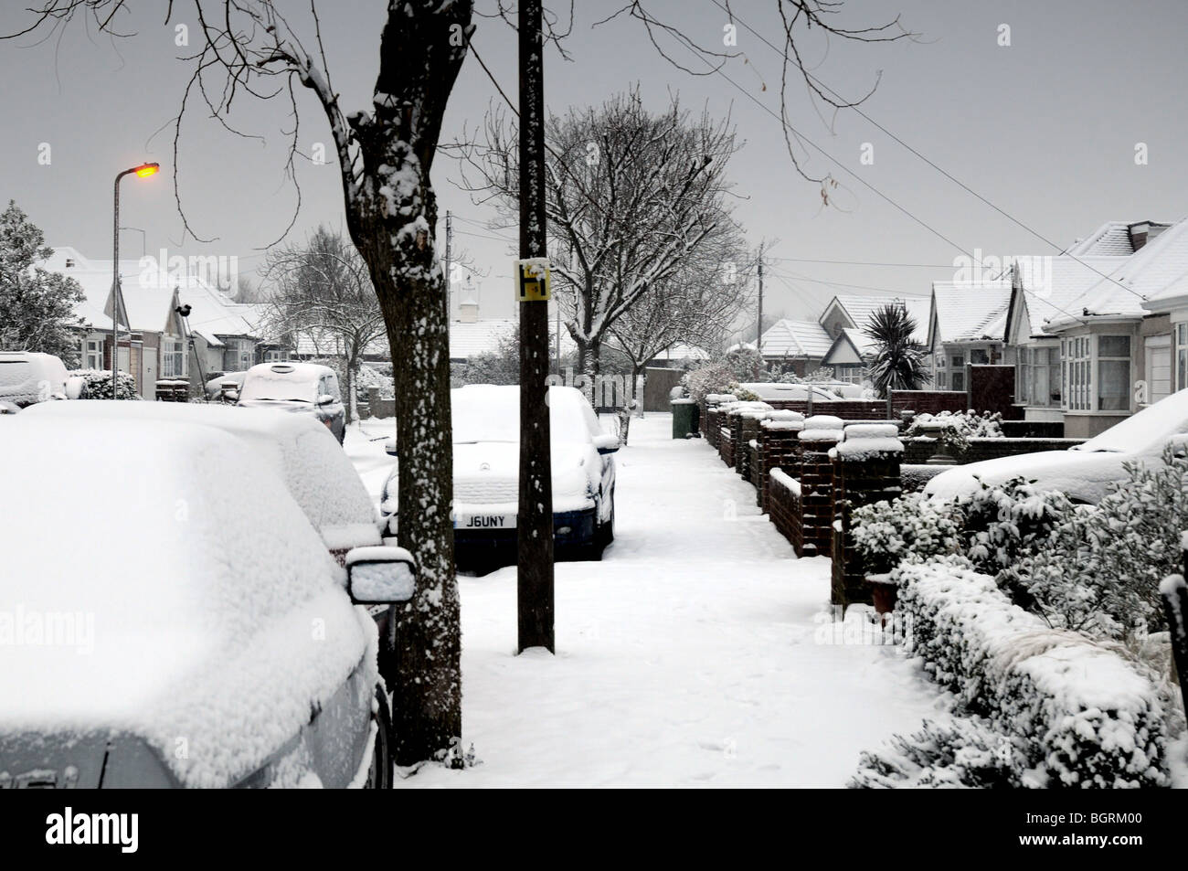 Suburban road covered in thick snow Stock Photo