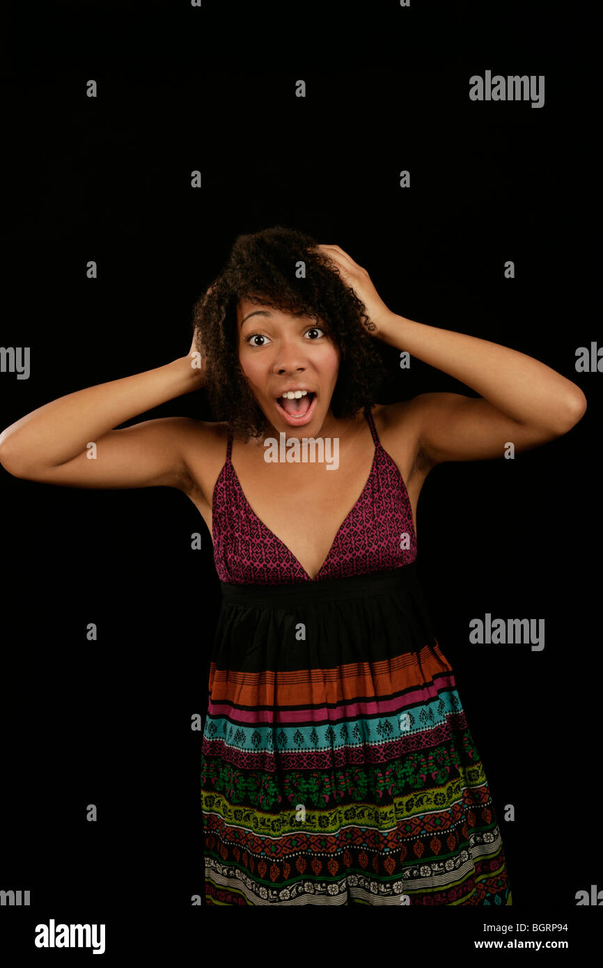 young woman with frizzy hair with a shocked or startled expression on her face Stock Photo