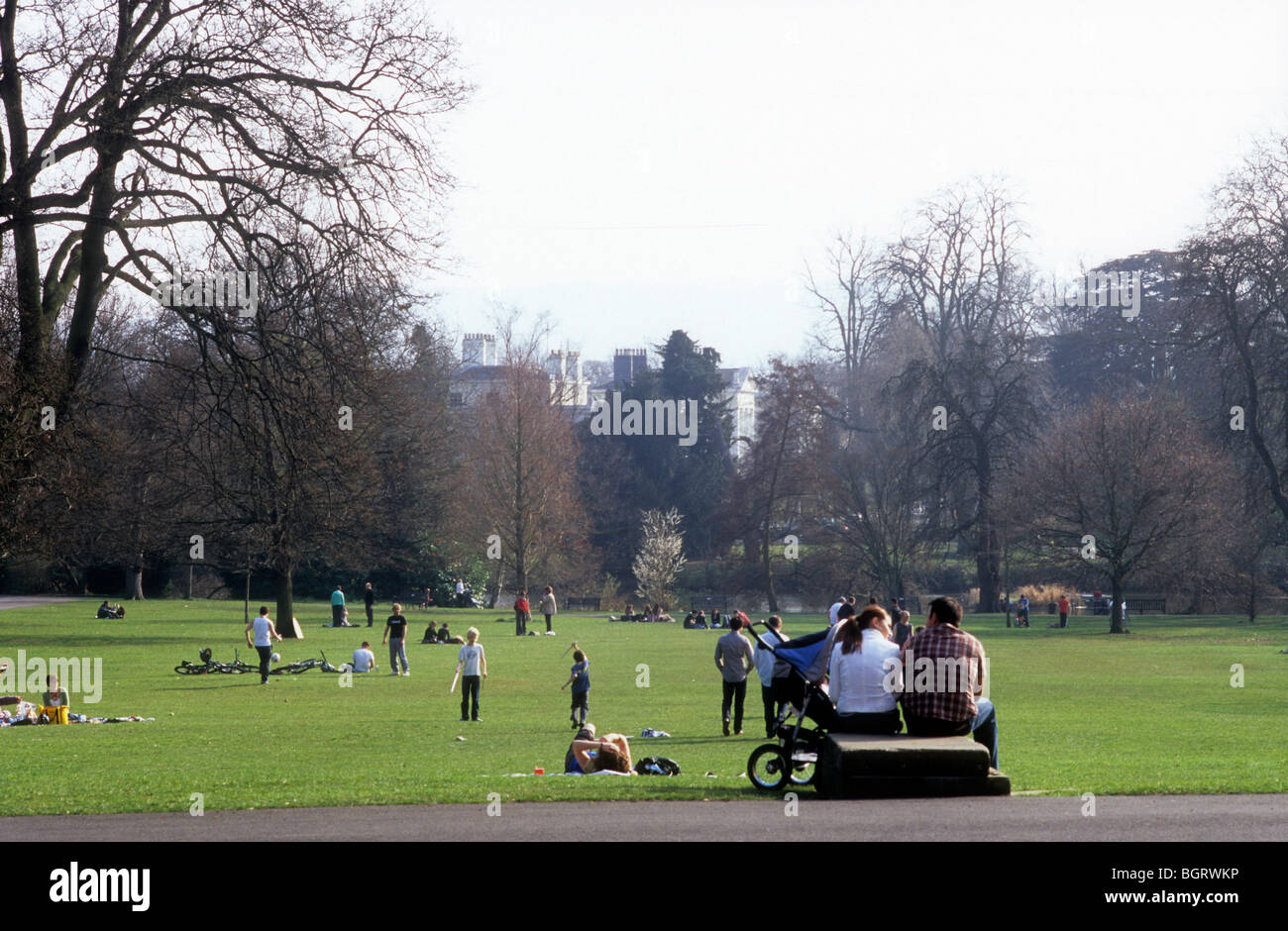 Families enjoying early spring day in Pittville Park, Cheltenham Stock Photo