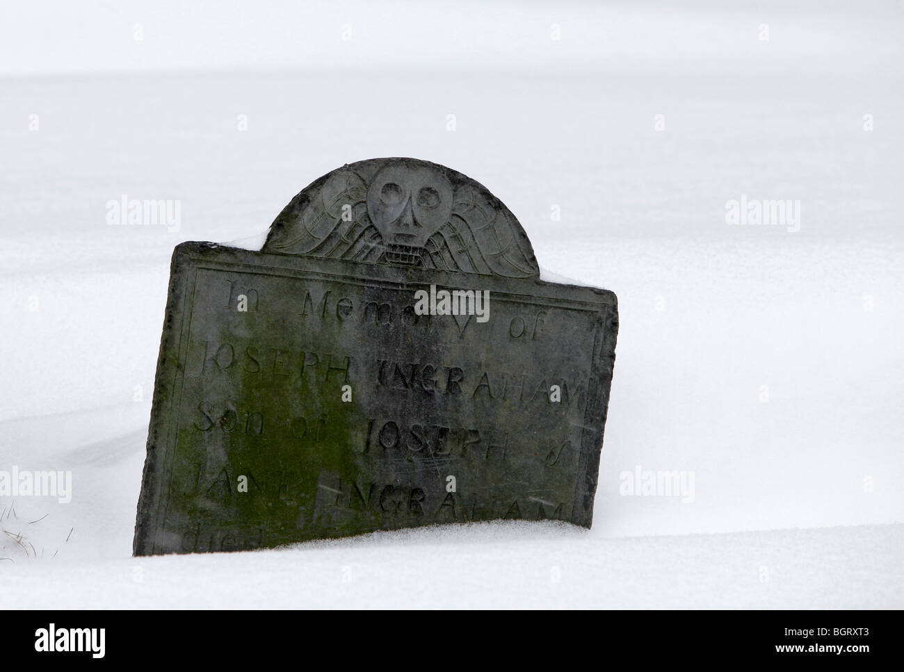 Old grave stone in the snow, Kings Chapel cemetery, Boston, Massachusetts Stock Photo