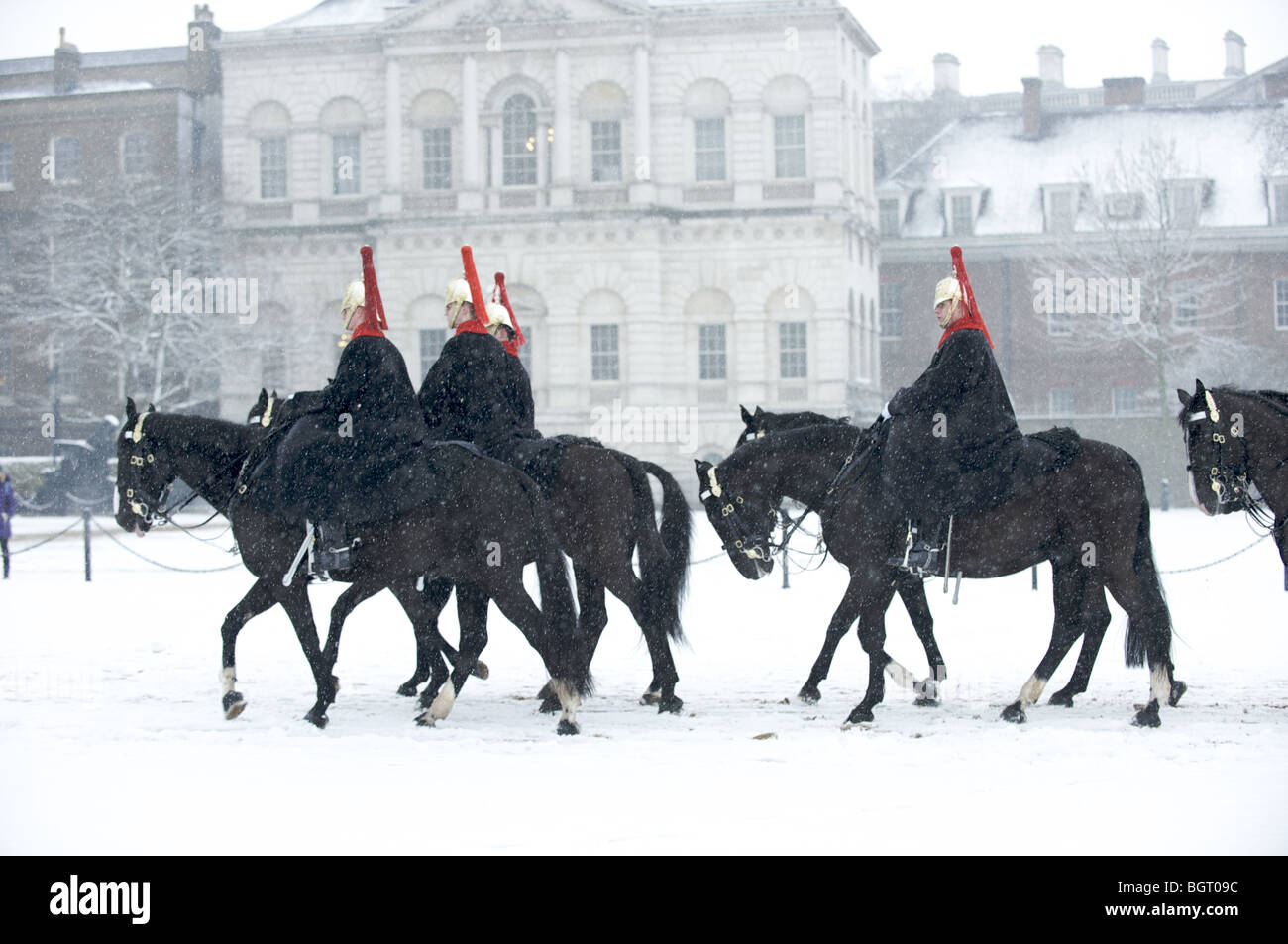 The Queen's Guard,  Blues and Royals cavalry regiment on horses in the snow, London, England Stock Photo