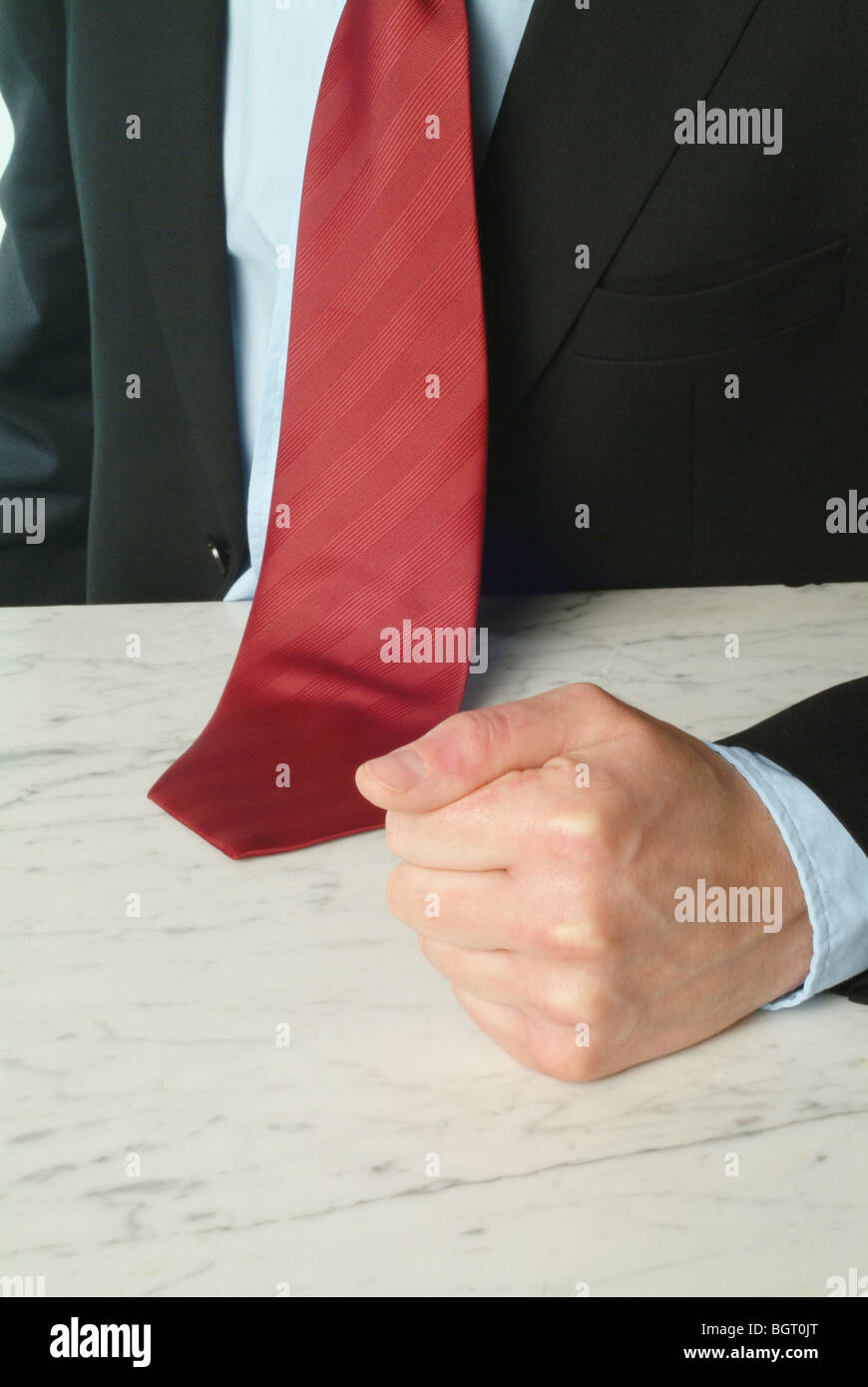 Man banging his fist on a table Stock Photo