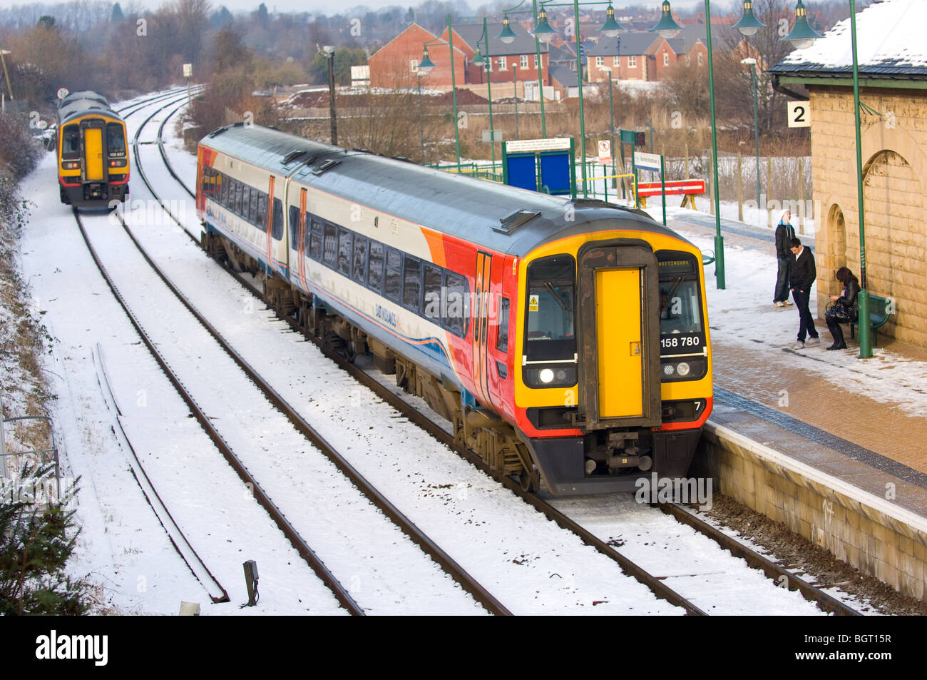 Commuter train pulling out of the local train station after a snow fall ...