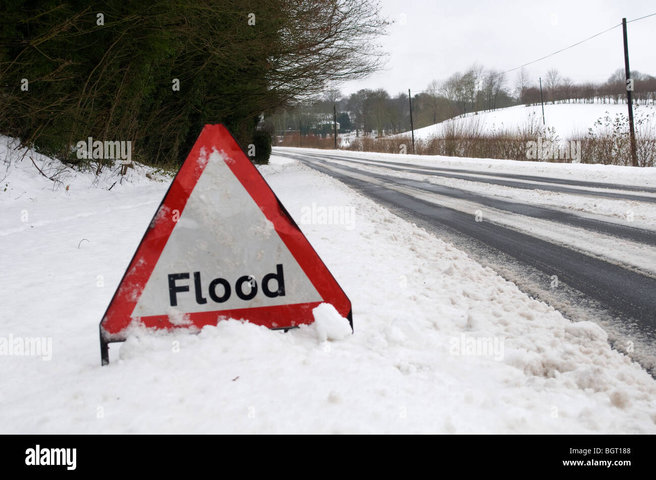 Flood Sign by road in snow Kent Countryside Stock Photo