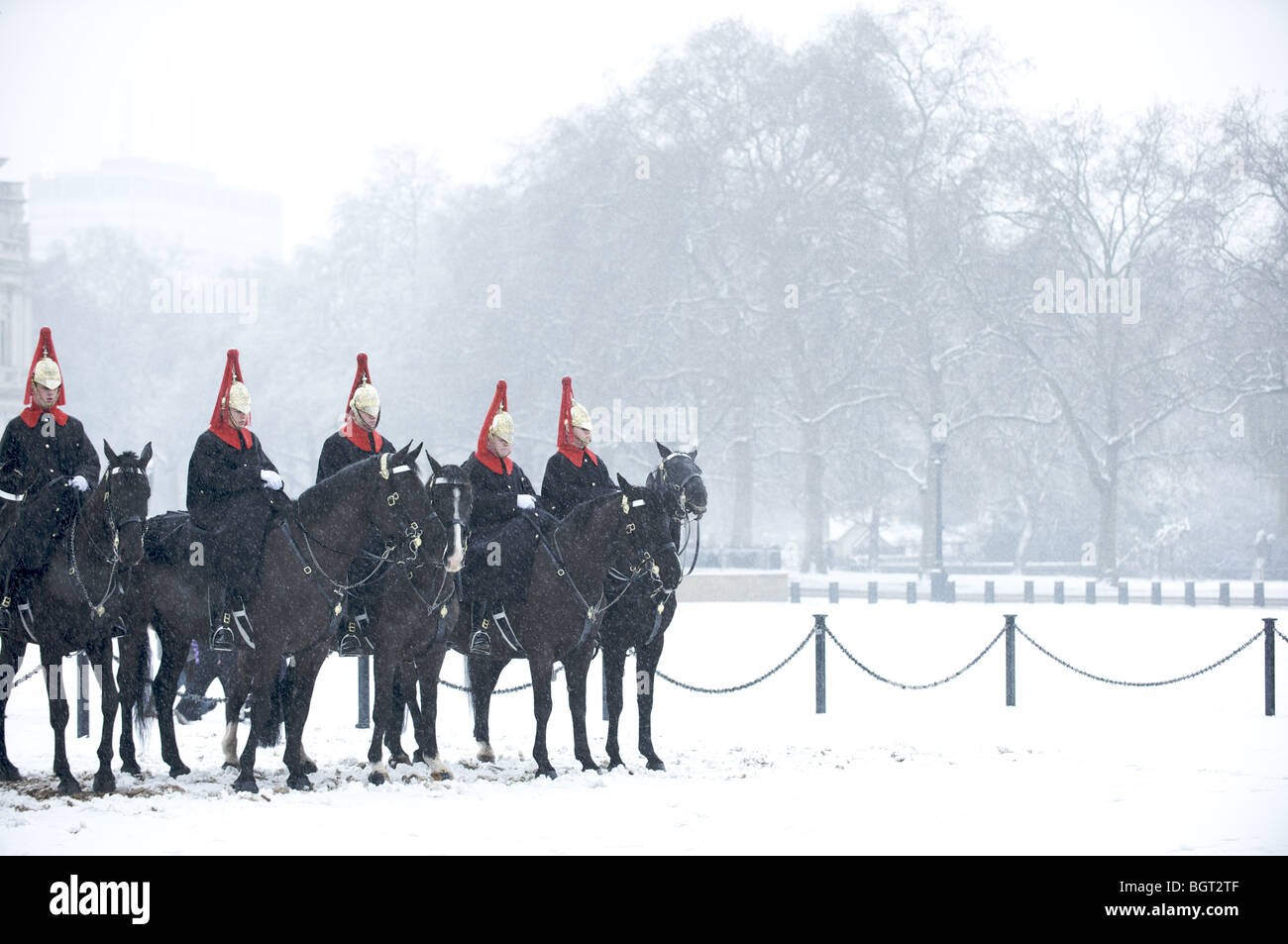 The Queen's Blues and Royals cavalry regiment on horses in the snow, London, England Stock Photo