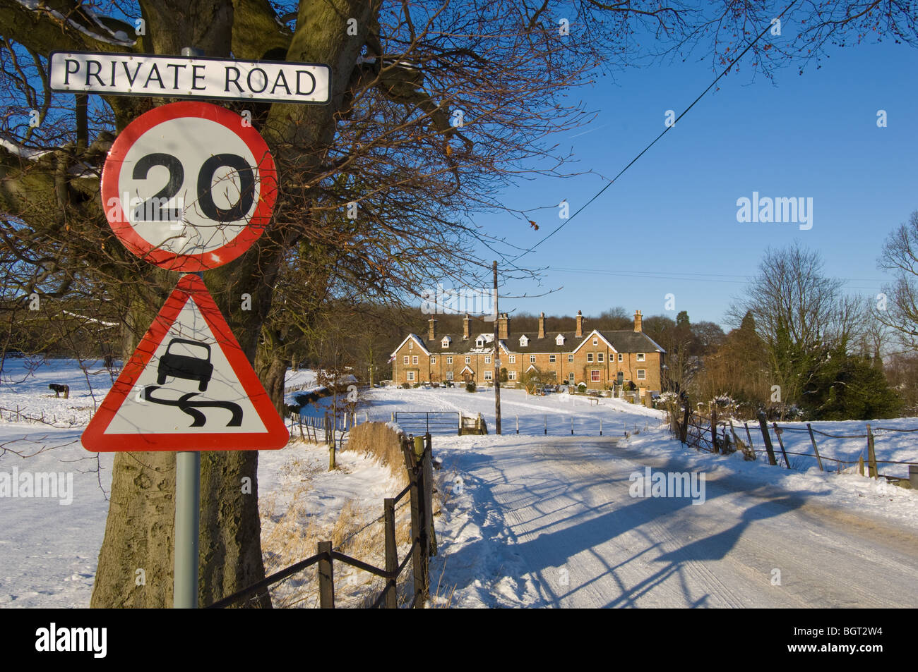 Warning signs, 20 m.p.h. and slippery road informing motorist of the hazard on the road leading to the village of Pleasley vale. Stock Photo