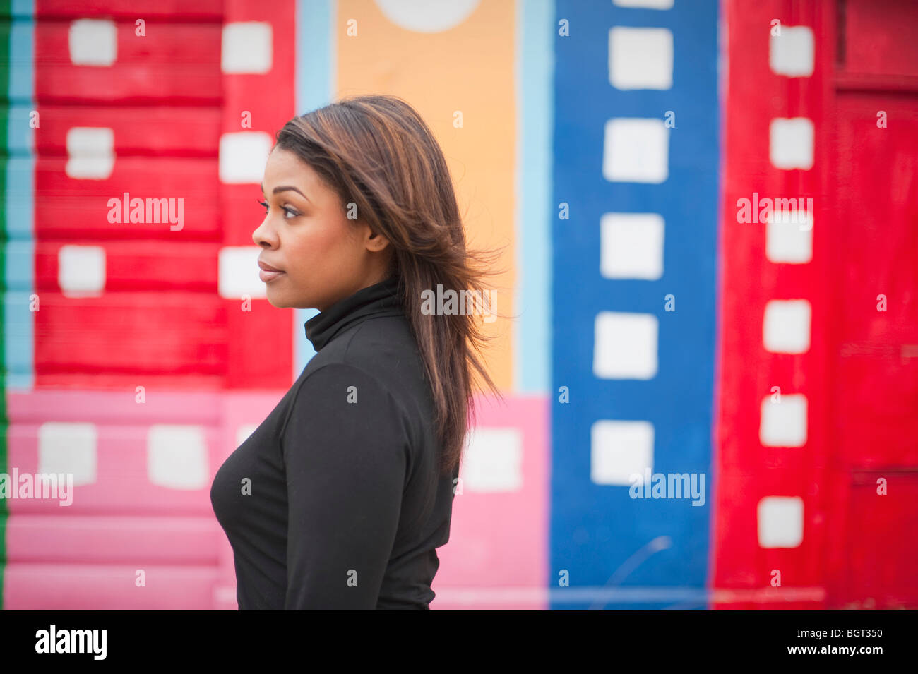 Woman standing in front of a mural Stock Photo - Alamy