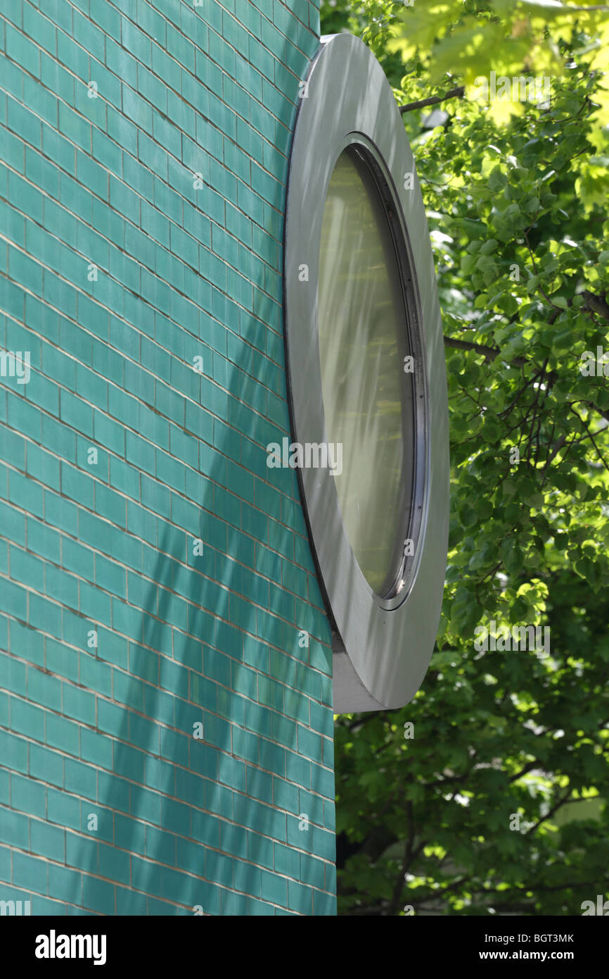 clock on glazed brick facade of emerald isle public toilets and flower