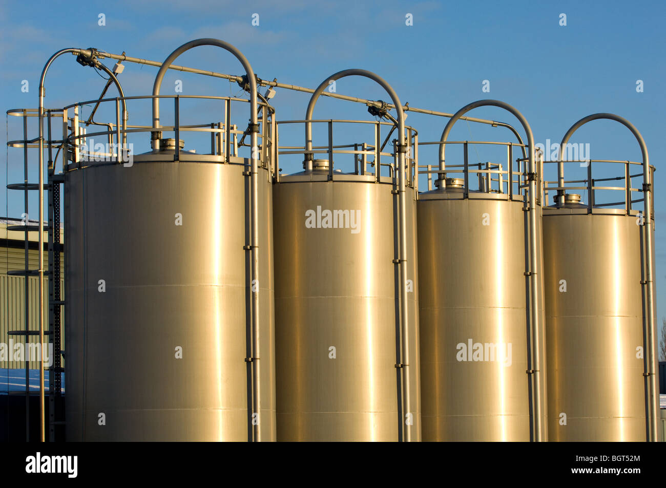 Four large aluminum bulk  containers silos for storing plastic pellet for the plastics industry Stock Photo