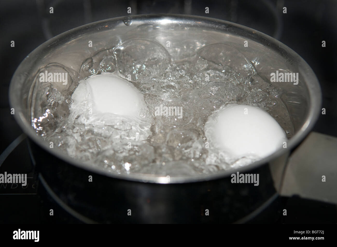 Eggs in boiling water Stock Photo Alamy