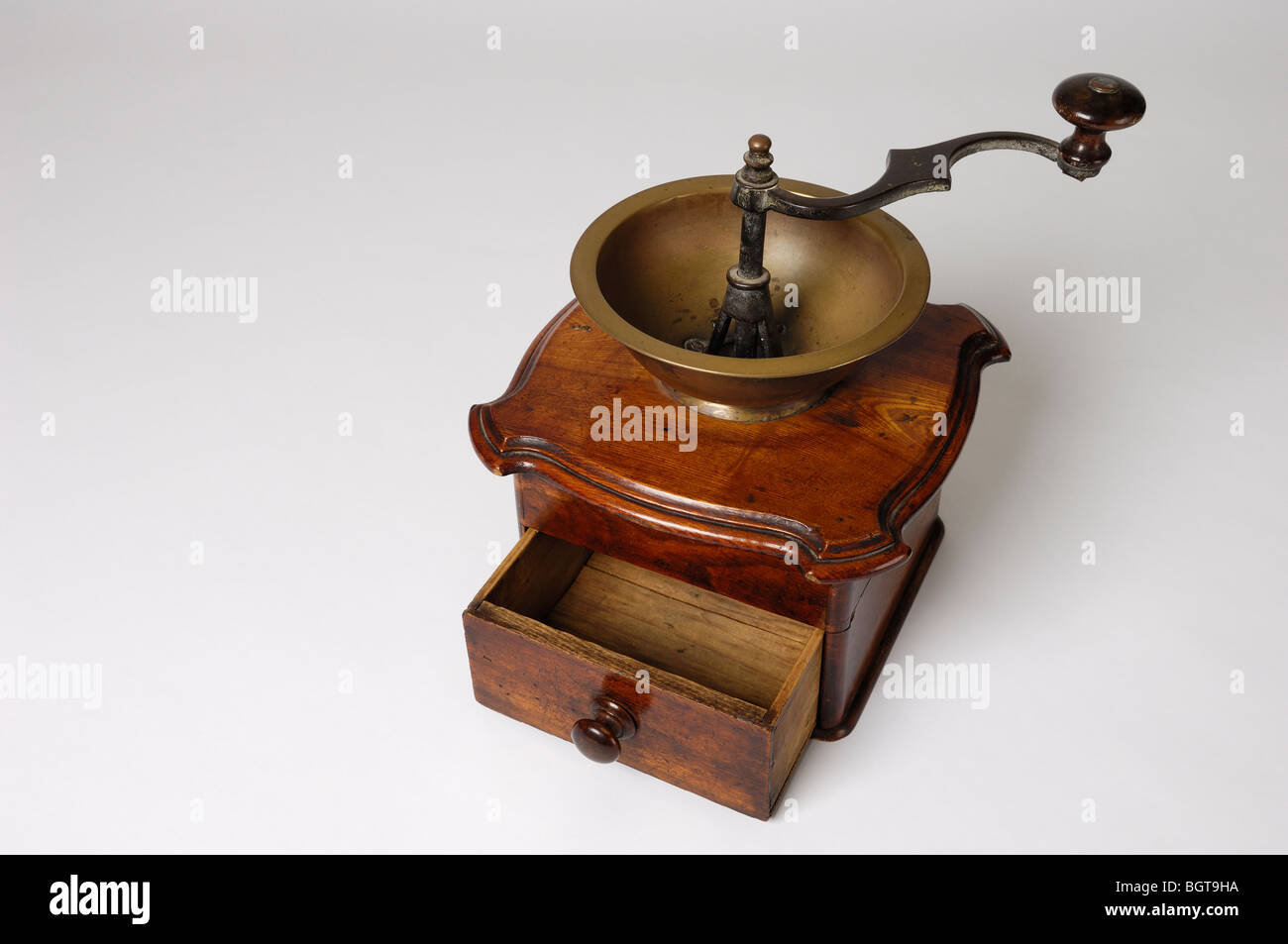 An antique coffee grinder or mill with pine wood case and metal 