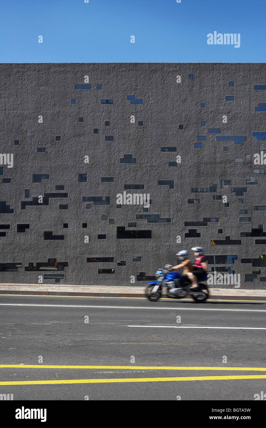 tea tenerife espacio de las artes, people ride past the concrete wall on a scooter Stock Photo