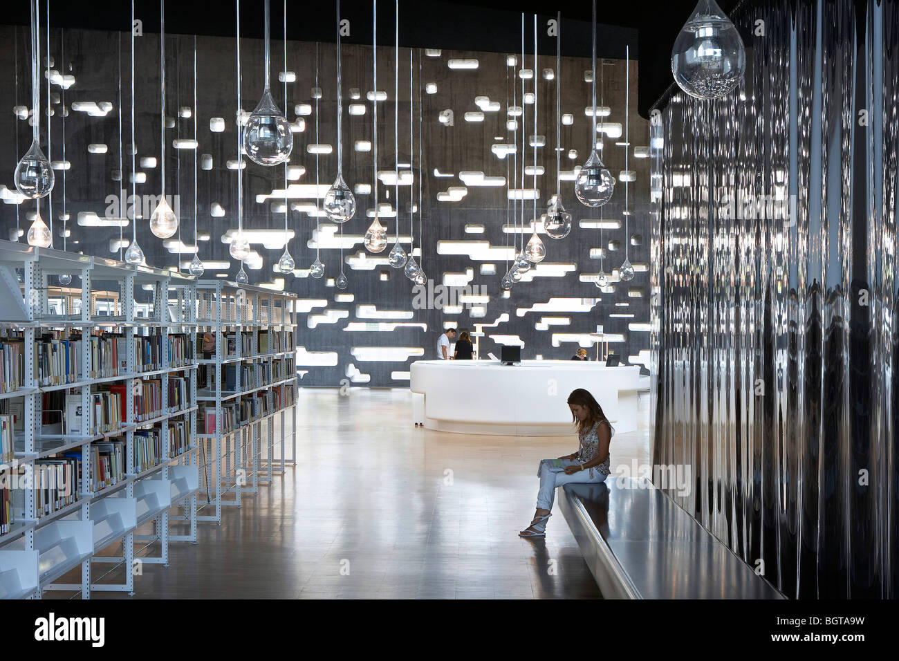 tea tenerife espacio de las artes, a young woman sits in the library reading area Stock Photo