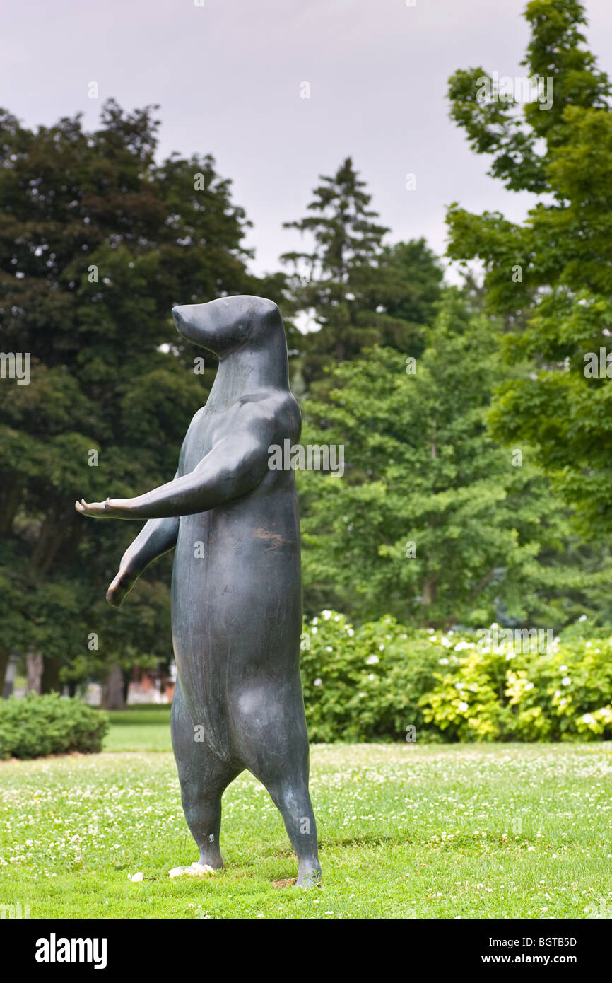 A bear statue holding its paw out. This statue is situated in front of