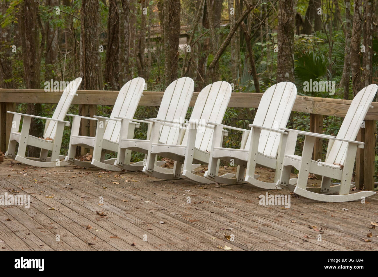 line-up of white rocking chairs at Silver Springs Florida Stock Photo