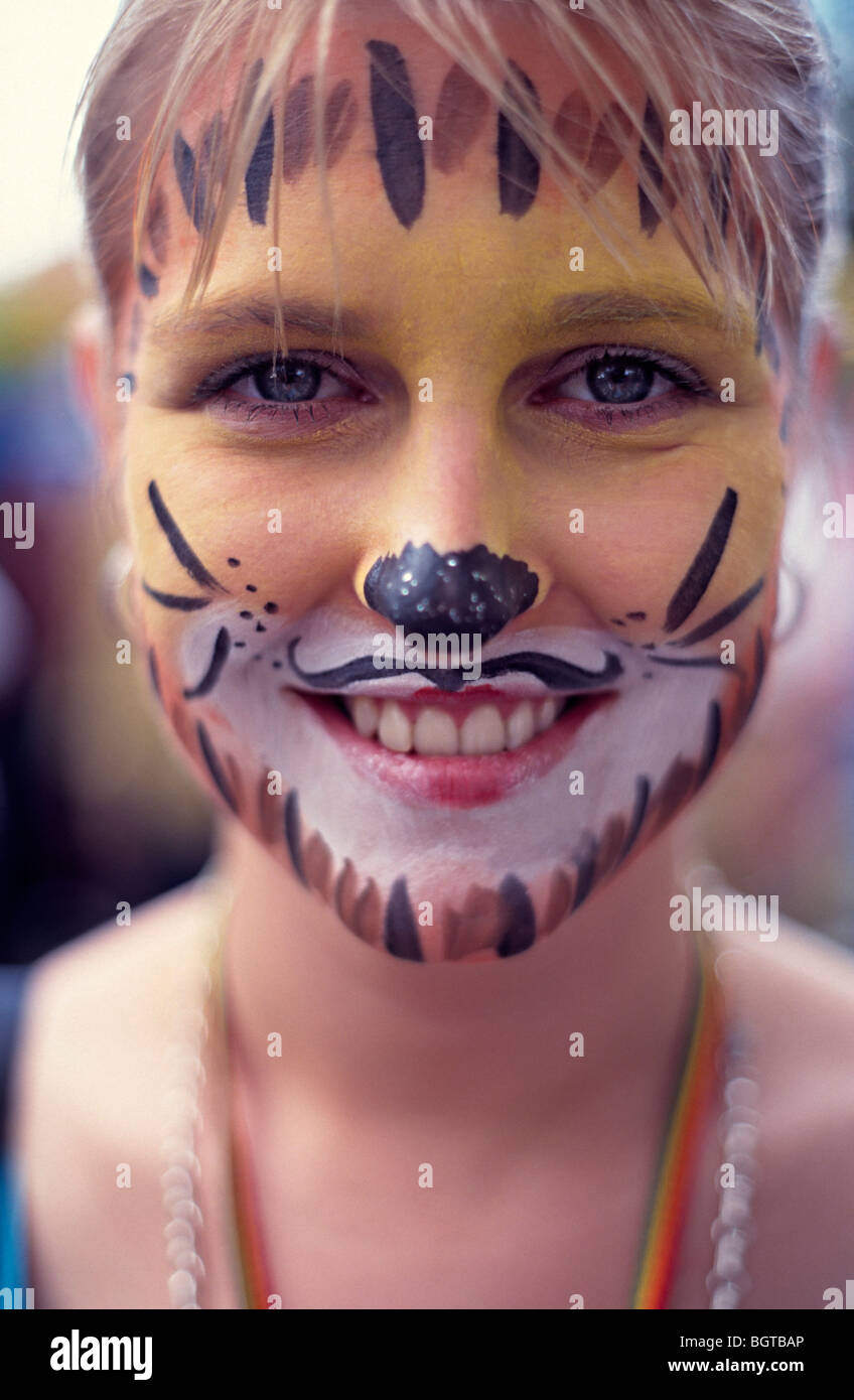 White girls portrait with a painted face as a cat at nottinghill carnival london Stock Photo