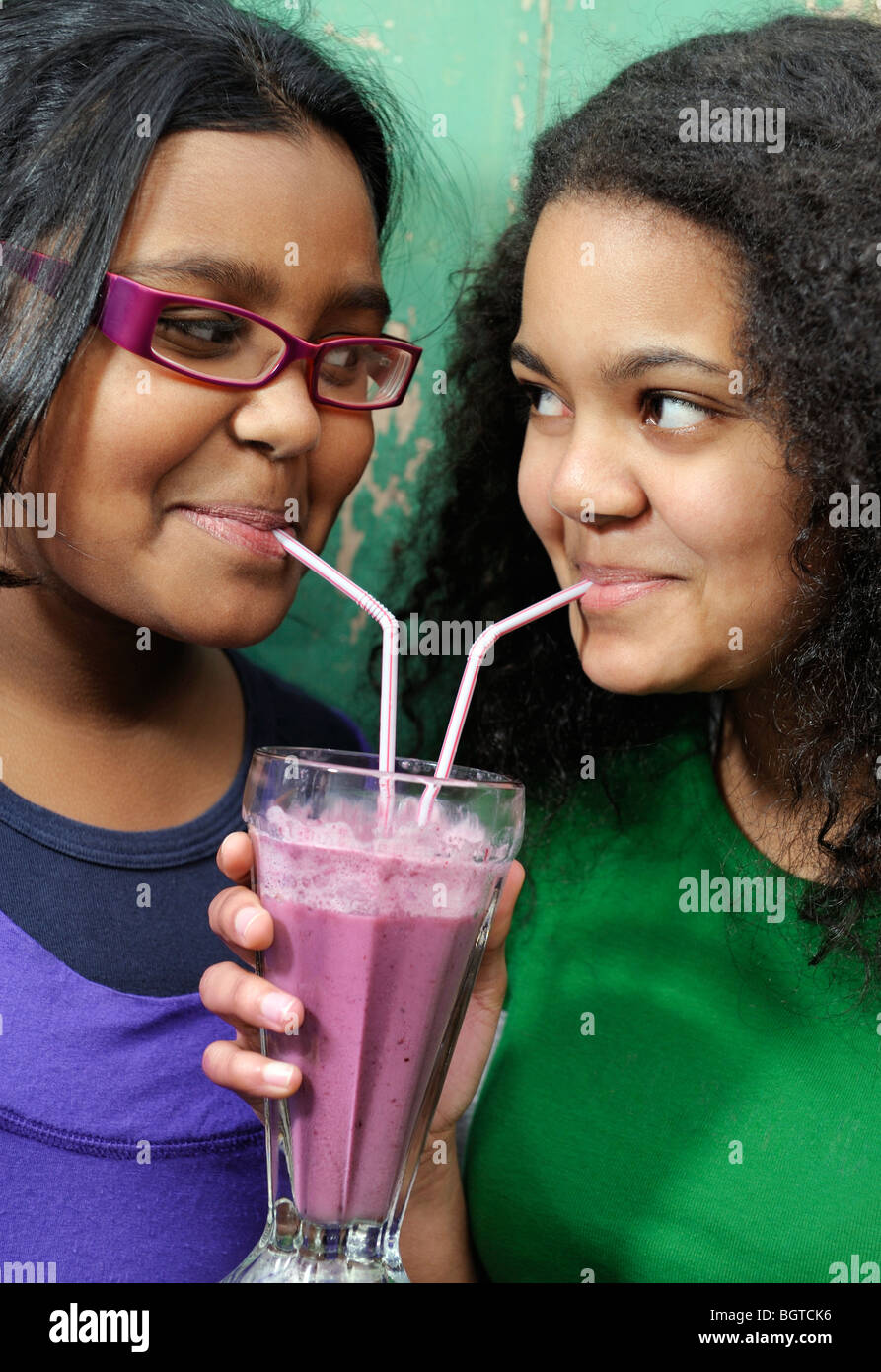 Teenage girls sharing smoothie, Cape Town, Western Cape , South Africa Stock Photo