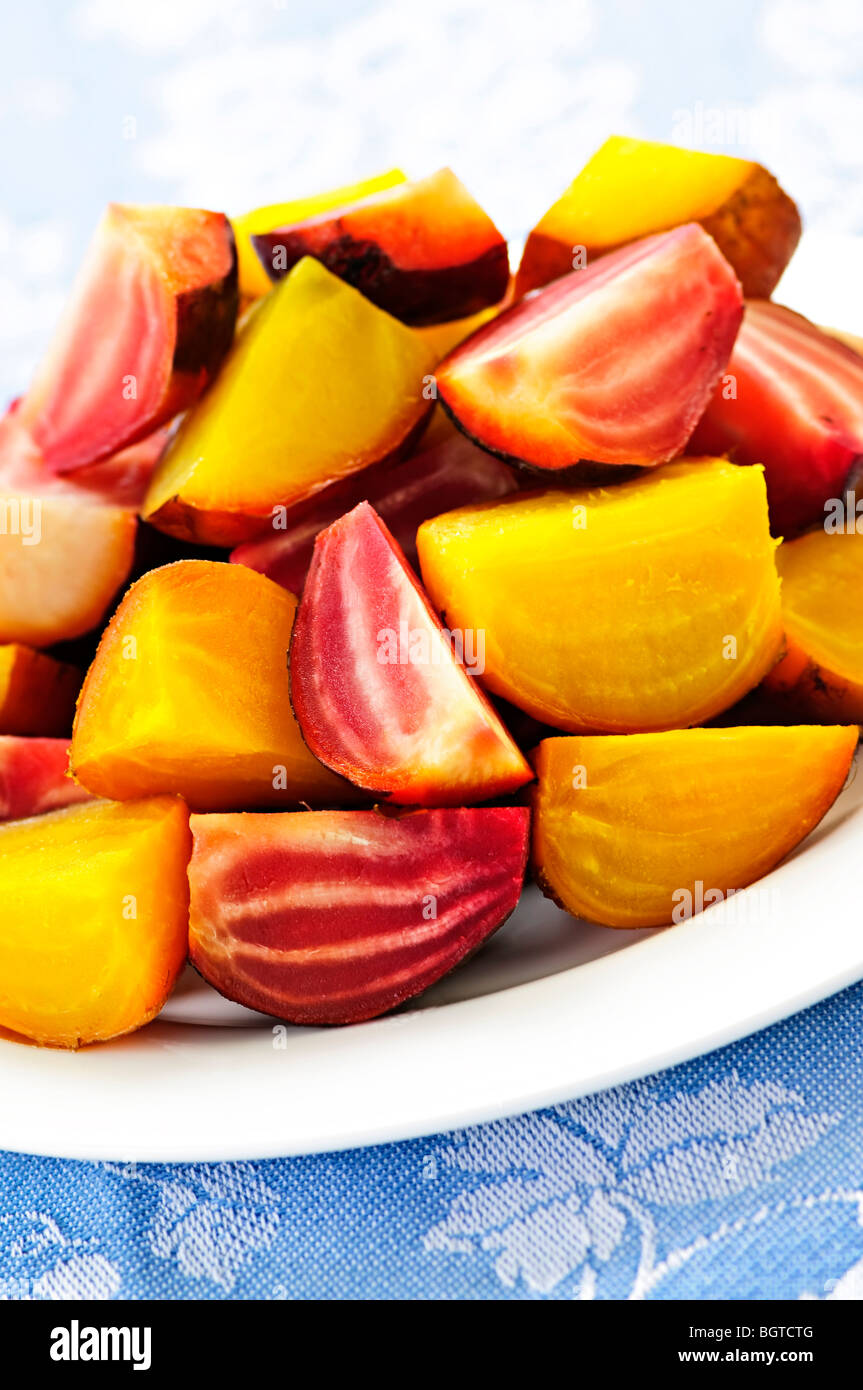 Closeup of roasted sliced red and golden beets on a plate Stock Photo
