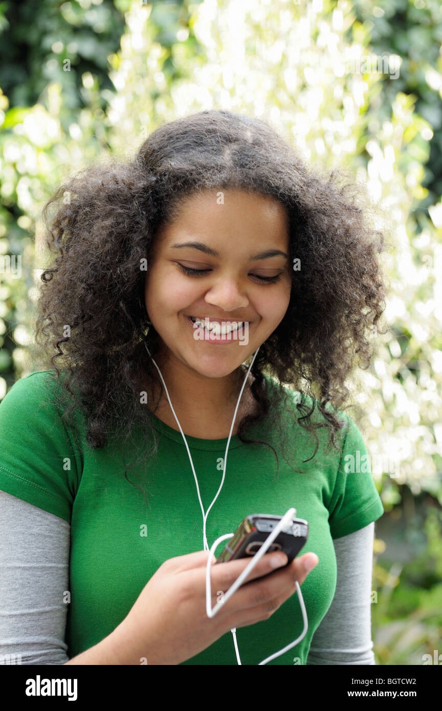 Teenage girl listening to music on mobile phone, Cape Town, Western Cape ,  South Africa Stock Photo - Alamy