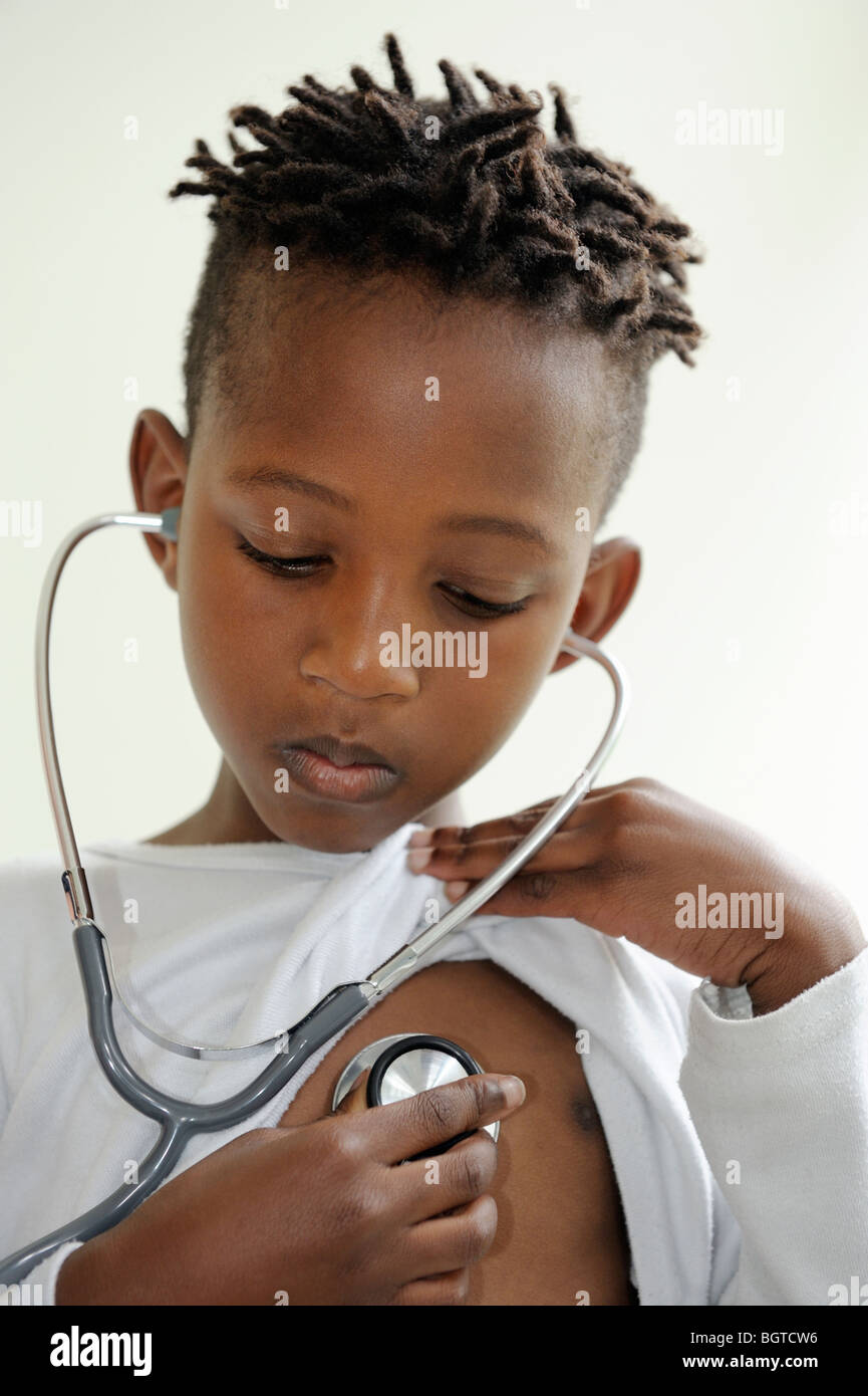 Boy listening to own heartbeat with stethoscope, Cape Town, Western Cape , South Africa Stock Photo