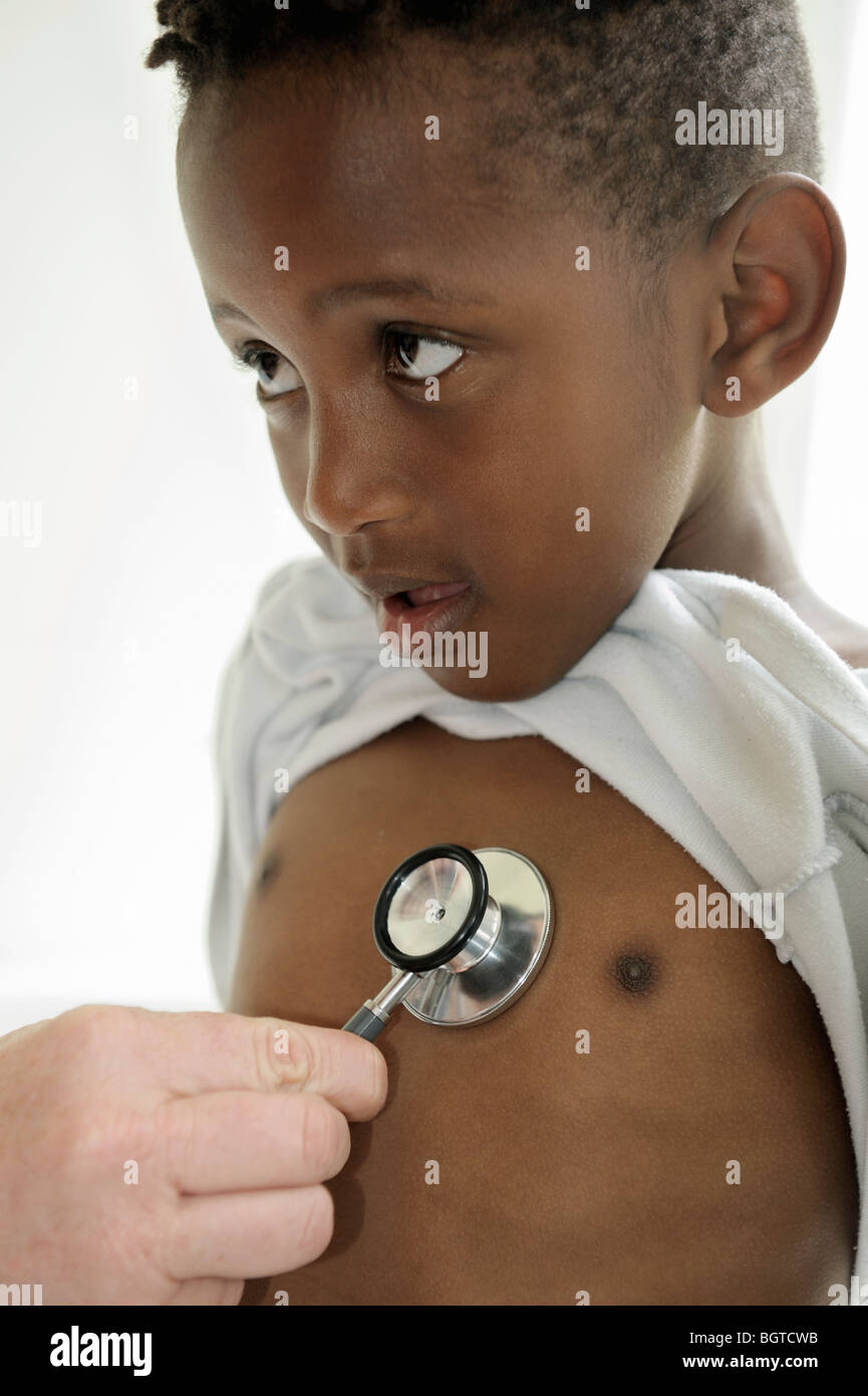 Boy with stethoscope being held on chest, Cape Town, Western Cape , South Africa Stock Photo