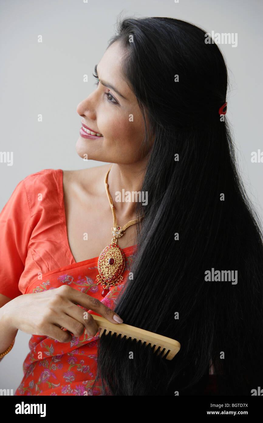 Indian Woman Smiling While Combing Hair Stock Photo 27582126 Alamy