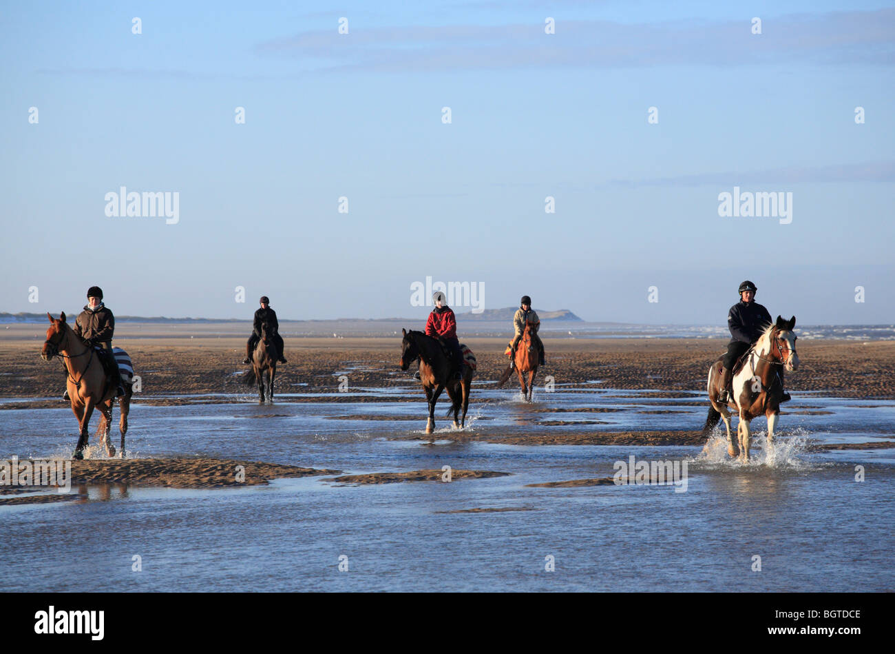 Five female riders on the beach between Holkham and Burnham Overy on New Years Day 2010 on the North Norfolk coast. Stock Photo