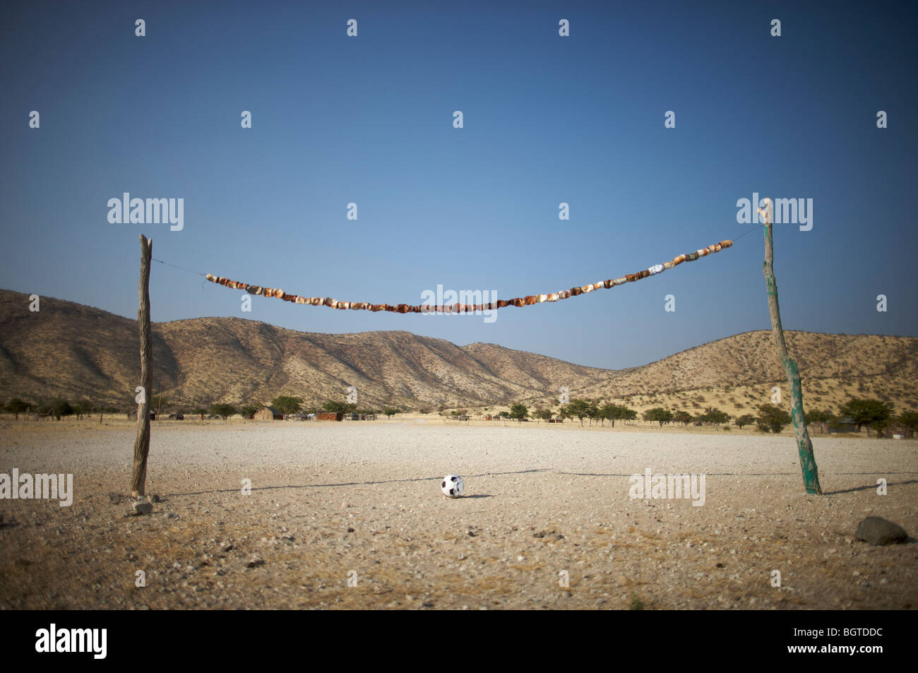 Rustic rural soccer field made of tree branches and cans, Epupa falls area, Kaokoland, Namibia Stock Photo