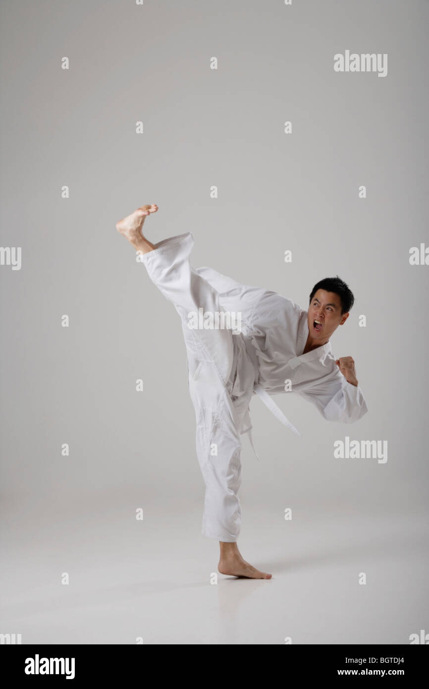 Man kicking high in the air, martial arts Stock Photo Alamy