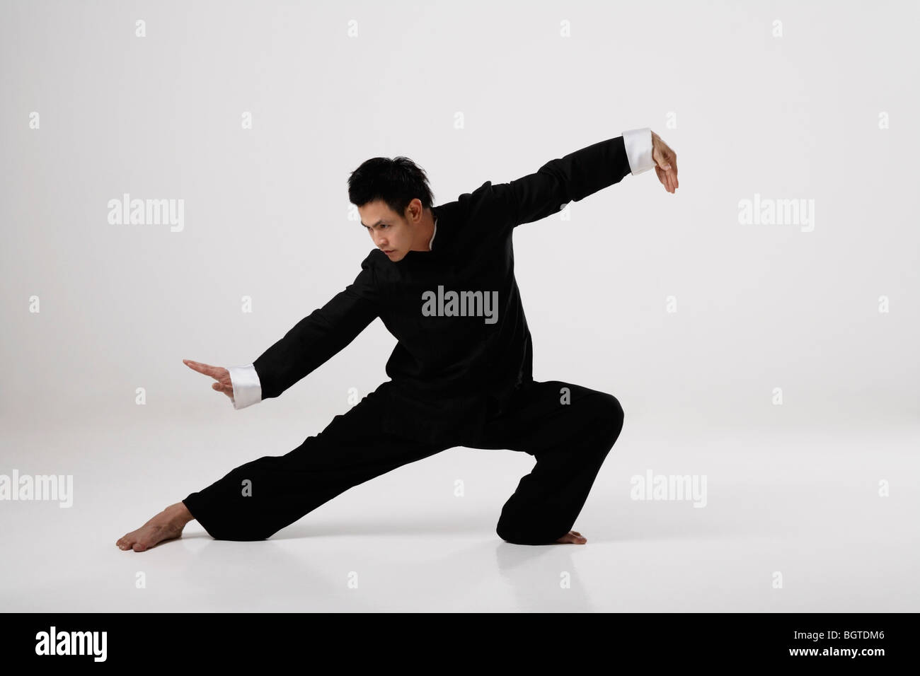 Man doing Tai Chi wearing traditional Chinese clothes Stock Photo