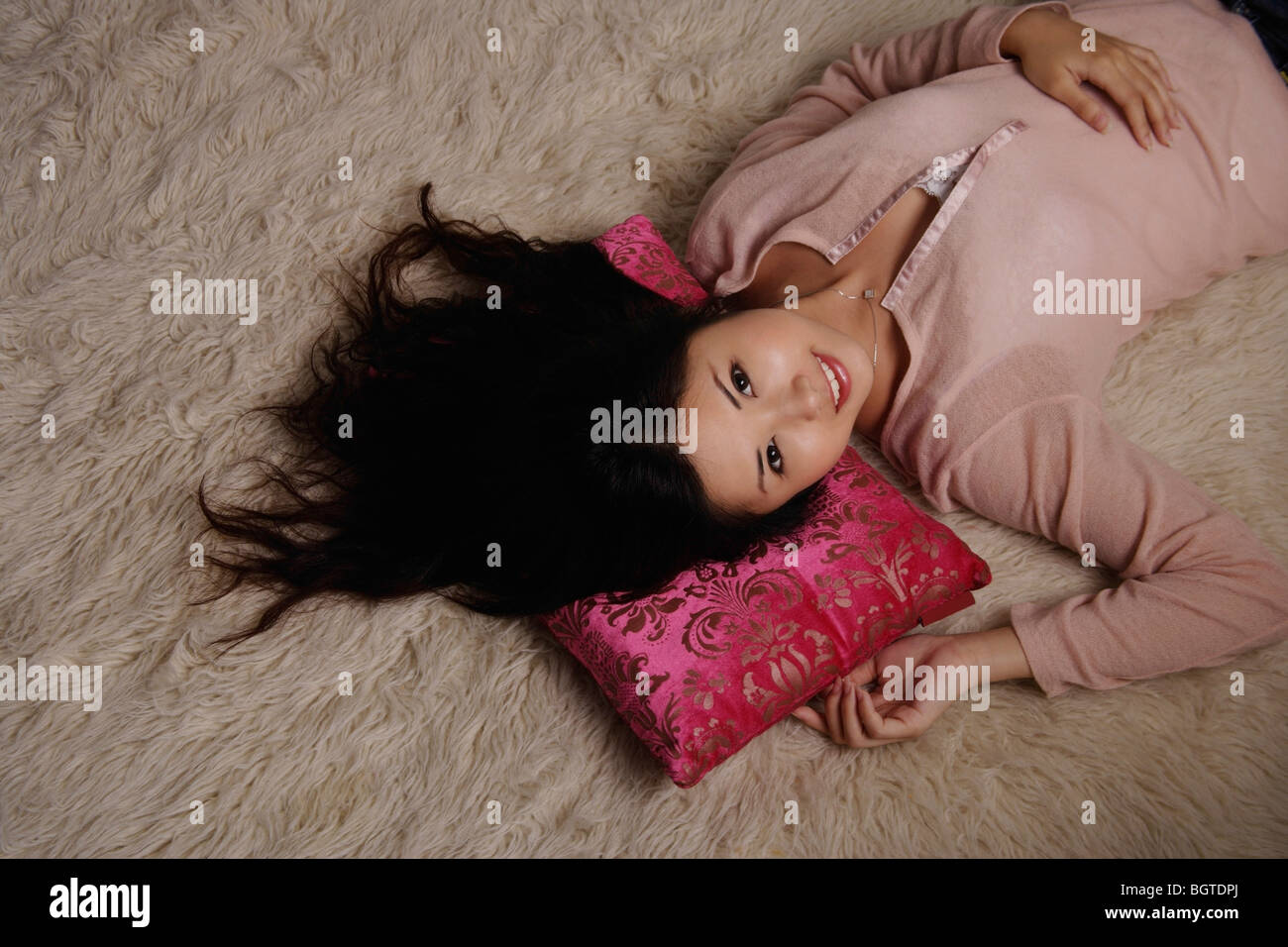 Chinese woman laying on rug Stock Photo - Alamy