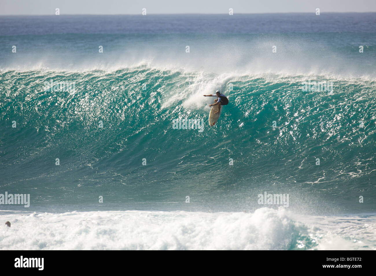 A surfer catches a large wave at Pipeline, North Shore, Oahu, Hawaii