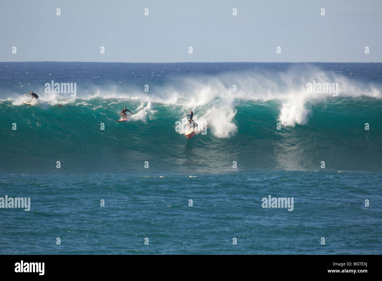 Two surfers collide on a large wave at Waimea Bay, Oahu, Hawaii Stock Photo